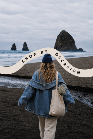 Person walking on a West Coast beach with text overlay 'Shop by Occasion' over ocean and rocks.