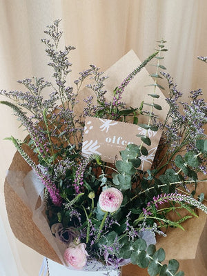 Wild textured bouquet with baby blue eucalpytus, limonium filler and ranunculus